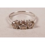 A 14ct white gold, three stone diamond ring, approximately 90 points, approximate size 'N'