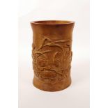 A Chinese bamboo brush pot with carved decoration of carp in a lotus pond, 7" high