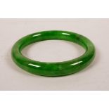 A Chinese apple green jade bangle, 2¾" diameter