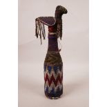 An African Yoruba beaded bottle and stopper in the form of a bird, 12" high