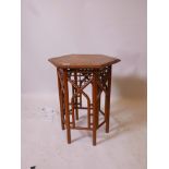A C19th Liberty style ash and elm occasional table with painted brass mounts, and pierced decoration