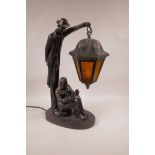 A contemporary 'Crosa' bronzed composition lamp in the form of a man reading beneath a lantern