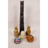A pair of soapstone bookends carved as parrots, 15½" high, a carved totem pole, 5½" high, a carved