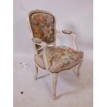 A Continental style carved and painted open armchair