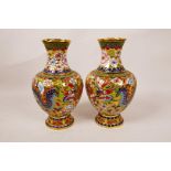 A pair of Chinese gilt metal and enamel vases decorated with a dragon and phoenix, 8" high