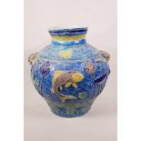 A large Chinese blue ground jar with two mask handles, the body with raised carp decoration, 8