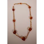A string of amber beads with faceted honey amber feature beads, 31½" long