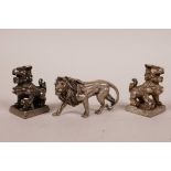 A pair of Chinese white metal seals in the form of kylin, together with a small white metal lion,