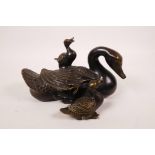 A Chinese filled bronze figure of a duck and ducklings, 7½" long