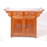 A Chinese hardwood cupboard with two drawers over two doors, 39" x 16", 31½" high