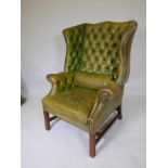 A Georgian style wing back armchair with buttoned back leather upholstery, A/F, some damage to