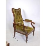 A C19th rosewood recliner chair, with shaped back and scroll arms, raised on carved and turned