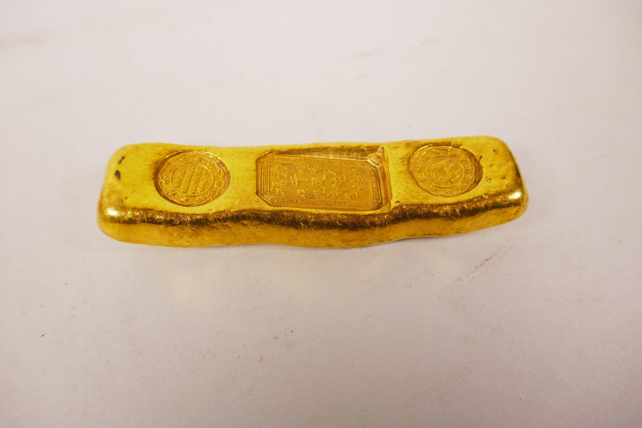 A Chinese gilt white metal trade token/ingot, 4" long, 190 grams - Image 2 of 3