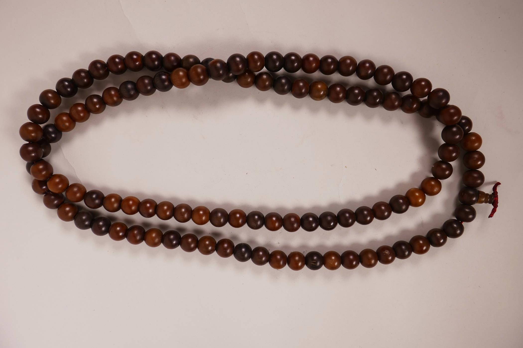 A string of horn beads, 58" long