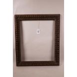 An antique English oak picture frame with carved gadroon decoration, aperture size 14½" x 12"