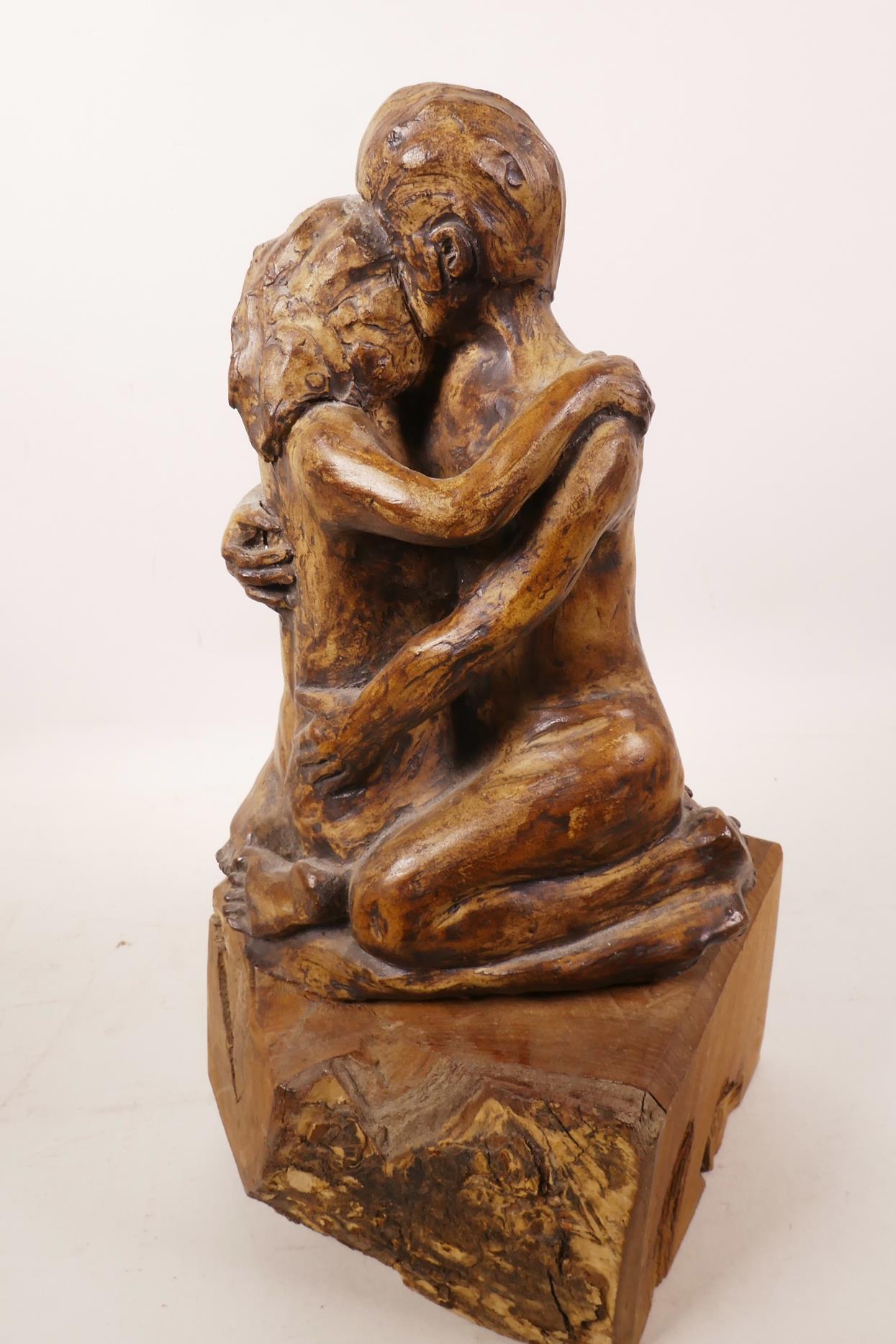 An art pottery figurine of a lovers' embrace mounted on a wooden plinth, 13½" high - Image 3 of 3