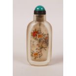 A Chinese reverse painted glass snuff bottle decorated with birds amongst flowers, 3" high
