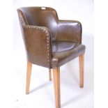 A green leatherette tub chair, 32" high