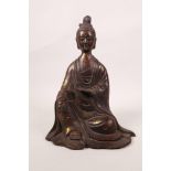 A Chinese bronze figure of a priest with gilt and copper patination, inscription verso, 9" high