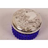 A blue glass dressing table pot with Art Nouveau style white metal lid, 2½" diameter