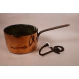 An antique copper and steel saucepan and a cast metal and porcelain coat hook, pan 7½" diameter
