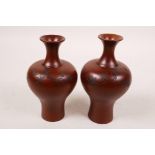 A pair of Chinese redware vases with raised flowering branch decoration, impressed mark to base,