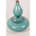 A Chinese stoneware double gourd shaped vase, with high fired dappled green glaze, 8" high