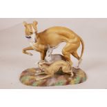 A Bisque porcelain figurine of a greyhound with two pups, 8" high