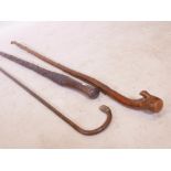 A Vintage African carved hardwood walking stick, a hedgerow walking stick, and bamboo cane with