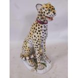 A large mid century Italian ceramic seated leopard, 30" x 19" x 12", with green glass eyes, signed