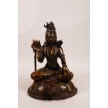 A Tibetan bronze figure of Buddha seated on a tiger skin with a flaming staff/trident, impressed