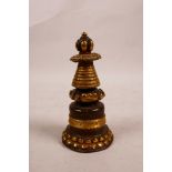 A Tibetan gilt and coppered metal stupa, 4" high