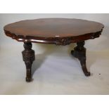 An early Victorian rosewood shaped top centre table, raised on carved end columns and cabriole