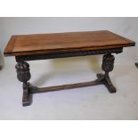 A Victorian oak draw leaf refectory table with a carved frieze, raised on carved bulbous end