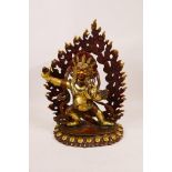 A Tibetan bronze figure of a wrathful deity with painted and gilt details, impressed double vajra