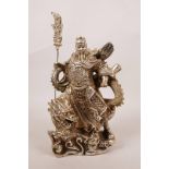 A Chinese silvered metal figure of a warrior deity standing on a dragon and carrying a halberd, 9"