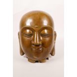 A Chinese bronze Buddha head, 8" high