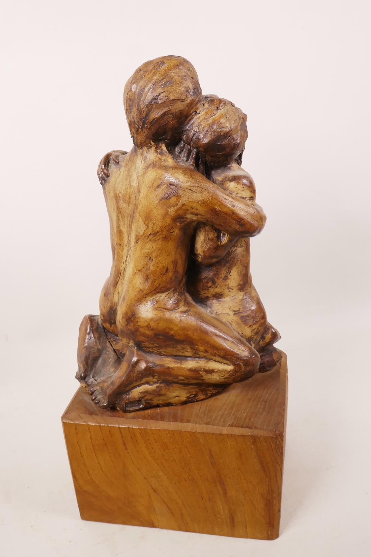 An art pottery figurine of a lovers' embrace mounted on a wooden plinth, 13½" high - Image 2 of 3