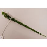 A Chinese green hardstone hair pin with a spiral stem and carved mythical creature to end, 7½" long