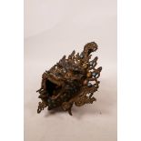 A Tibetan bronze mask censer in the form of an evil spirit with turquoise set panels, 7" x 10"