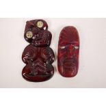 A Maori carved wood Hei-Tiki figure with abalone set eyes, together with a similar Maori mask (A/F),