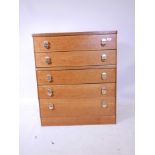 A mid century teak stag tallboy chest of five drawers with original brass handles, 17" x 32", 37½"