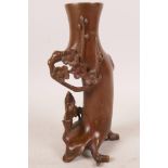 An Chinese coppered bronze spill vase in the form of a tree with a sage mounted on a donkey, 6" high