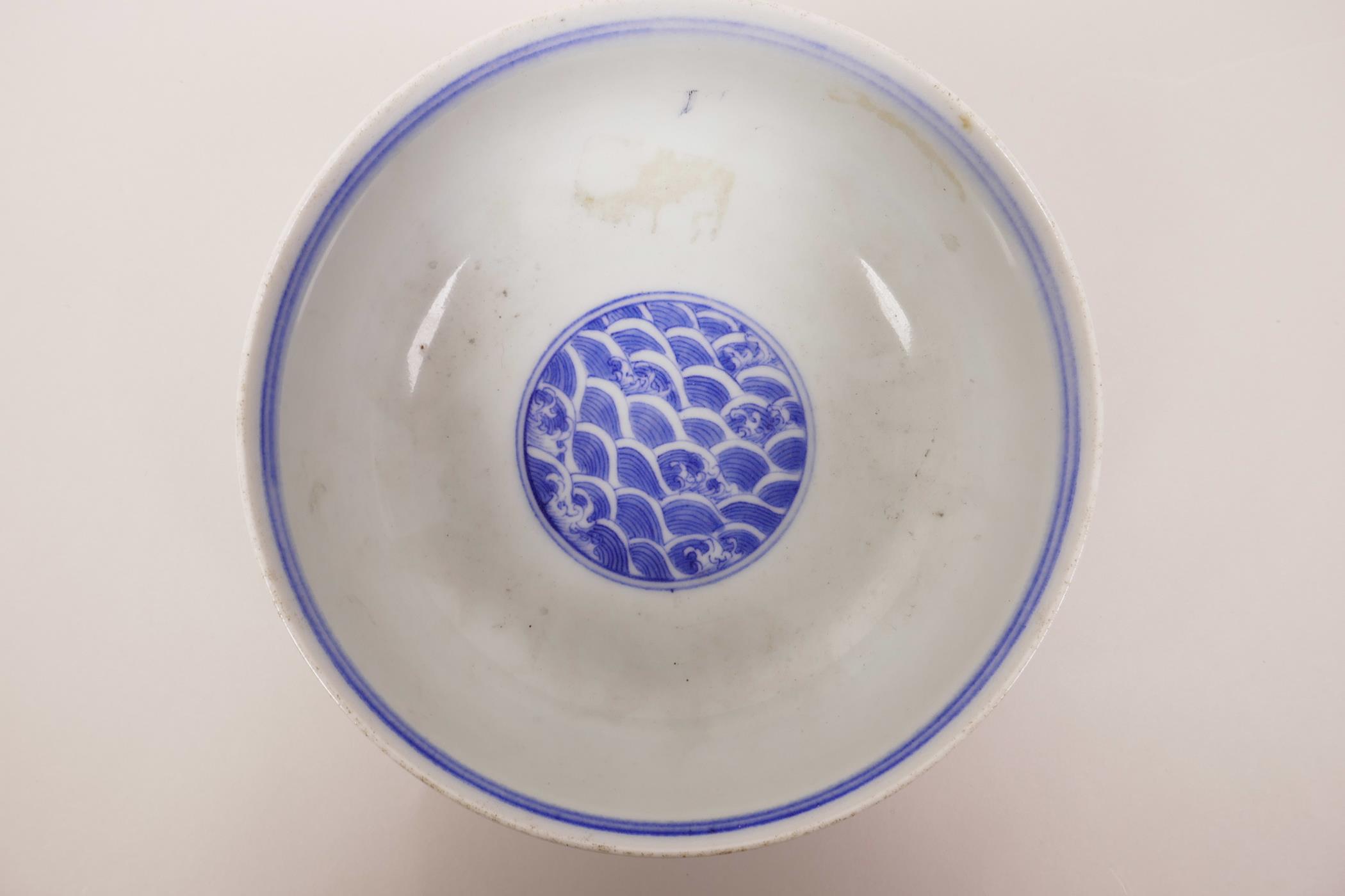 A Chinese blue and white porcelain bowl decorated with a dragon chasing the flaming pearl, 6 - Image 3 of 6