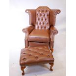 A reclining wing back armchair, with buttoned and studded leather and a matching footstool
