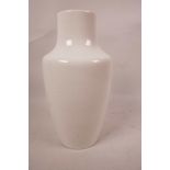 A white glazed high fired Ruskin pottery vase, 8" high