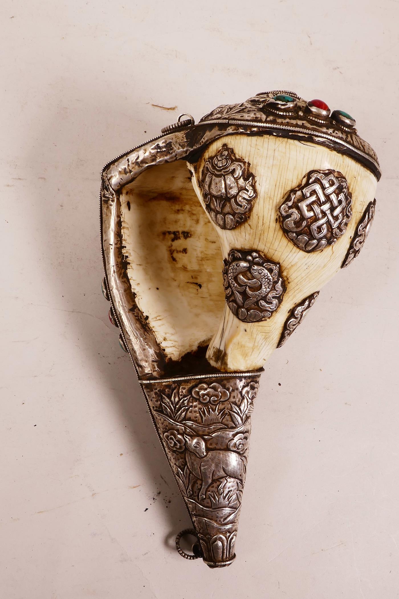 A large Tibetan white metal mounted conch shell, with repoussé decoration of the eight Buddhist - Image 4 of 4