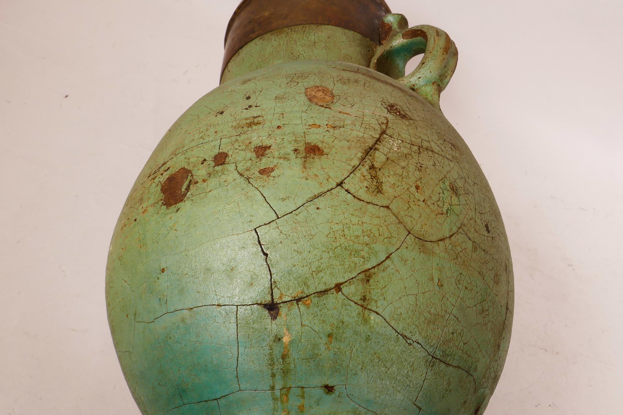 An Eastern pottery two handled vase with a turquoise glaze and copper rim, probably Indian, repair - Image 3 of 6