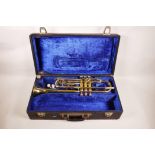 A B&M Champion brass trumpet, in a fitted case, 20" long