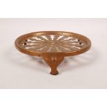 A pierced copper trivet by JS&S, 6" diameter